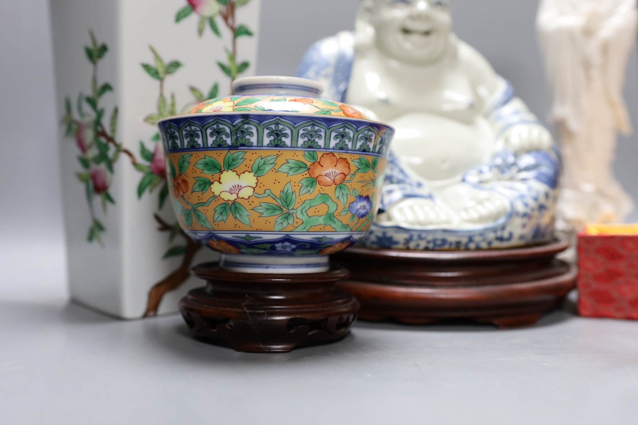 A Chinese peach vase, Buddha, two hardstone balls and a blanc de chine figure and a bowl and cover on stand, peach vase 32 cms high